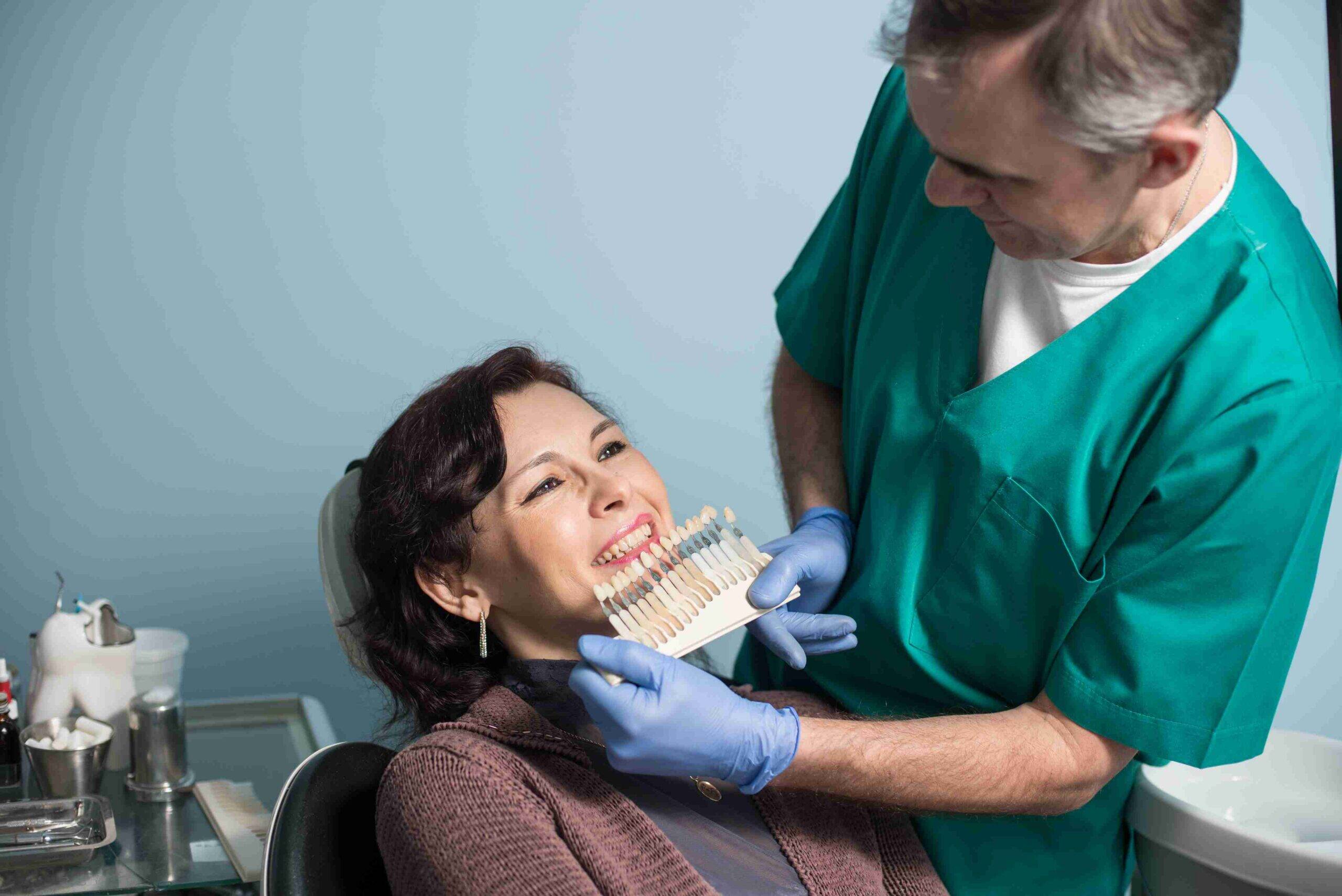 Dentist discussing tooth shade options with a smiling patient.