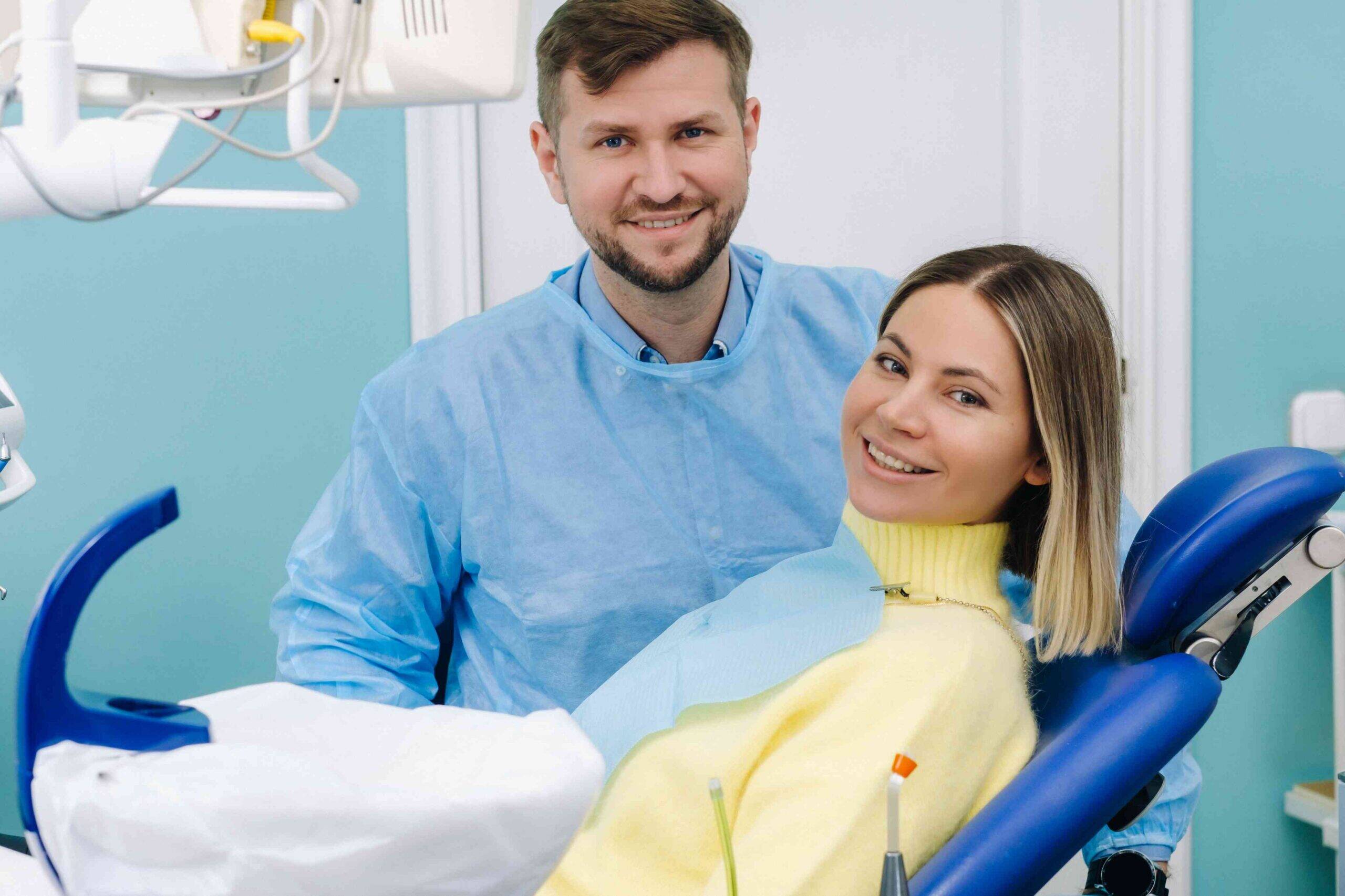 Smiling patient with dentist in a modern dental office.